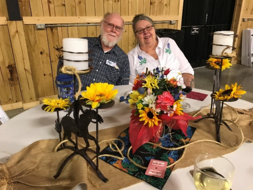 Couple sitting at table decorated in rustic theme.